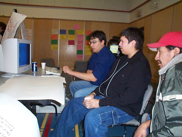 Jesse giving Blue and Lester Pascal a demonstration on the many uses of the computer programs.