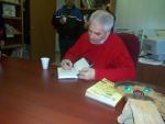 His Honor James K. Bartleman signs a copy of his book.