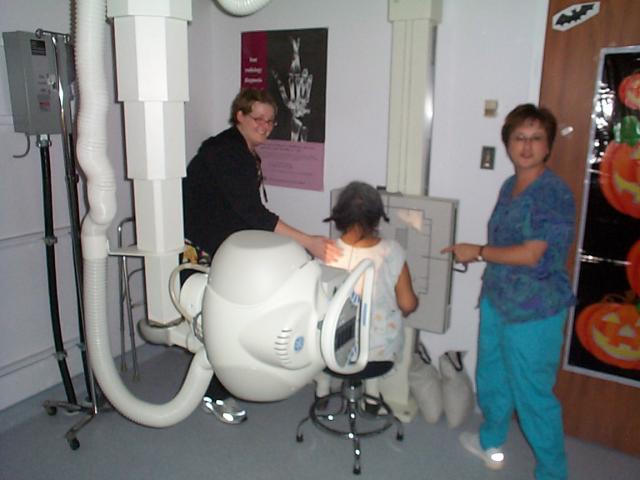 Getting her to sit still while pointing the X-ray machine on her back.