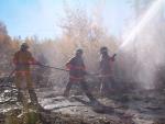 these fire fighters looks like they are really fighting a blaze