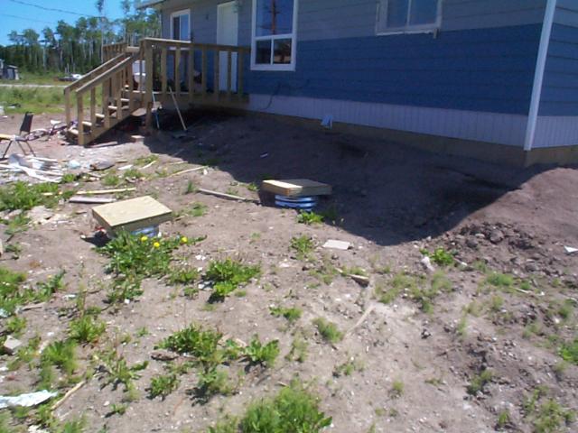 view of the front of the house, u see the boards covering the septic.