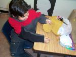 Another student working on his bead work using leather.