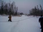 Here's one of the guys pulling on the rope which lifts the cable line up and attached to the telephone line.